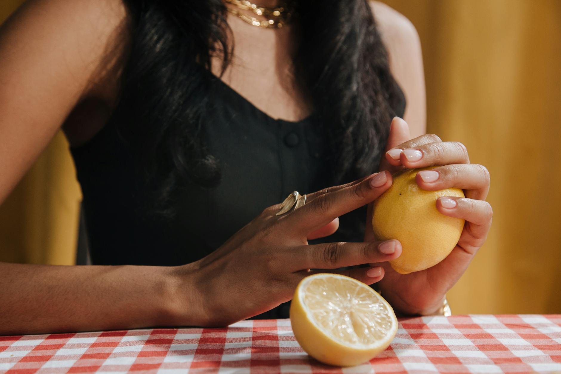 Woman holding a fresh lemon, symbolizing renewed freshness and vitality during stressful periods